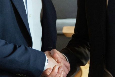 Two business partners shaking hands in agreement.